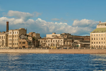 The ruins of the house at the Pirogovskaya embankment of the river Neva in Saint Petersbur is a bright summer day.