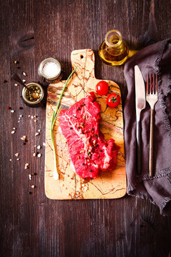 piece of raw meat with herbs and olive oil
