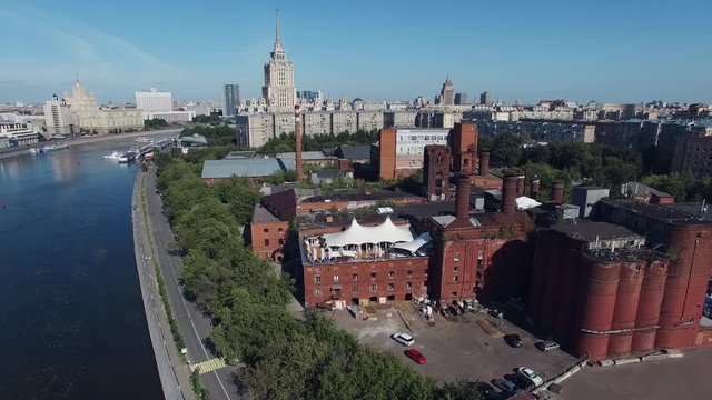 Quadrocopter shoot complex of old brick buildings among modern in center of Moscow city. Summer cloudless day