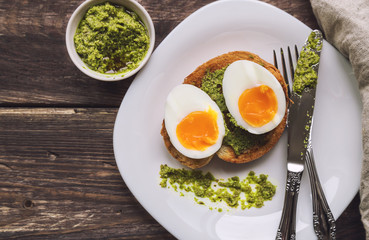 Toast with soft-boiled egg and pesto sauce