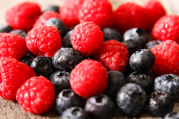 blueberries and raspberries on a gray stone background