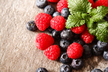 blueberries and raspberries on a gray stone background