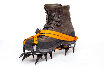 leather climbing boots with crampons, isolated on white background