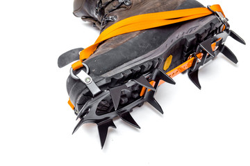 leather climbing boots with crampons, isolated on white backgrou