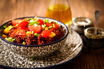 Quinoa with tomatoes chilli and corn on a plate