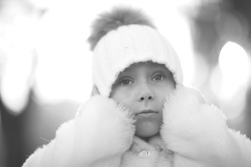 Obraz premium Pretty little girl in hat covering ears