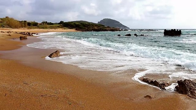 seascaoe with foamy swashing waves and cloudy sky