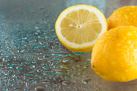 wet lemons on a glass surface