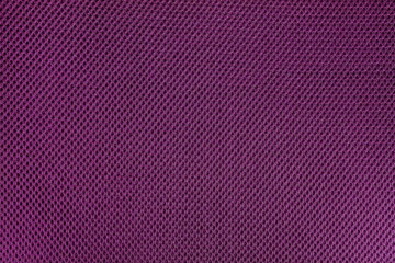 Pink fishnet cloth material as a texture background. Pink nylon