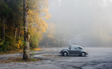 Obraz na płótnie Canvas Autumn park in the town of Fussen and a single car in the parking lot Fussen, Germany