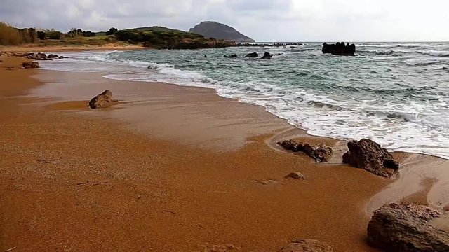 seascaoe with foamy swashing waves and cloudy sky