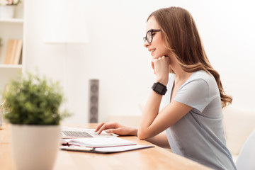 Positive girl sitting at the table