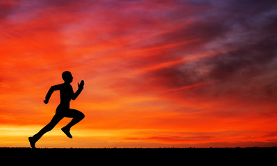 Fototapeta na wymiar Silhouette of running man against the colorful sky. 