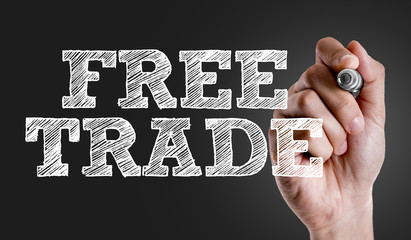Hand writing the text: Free Trade
