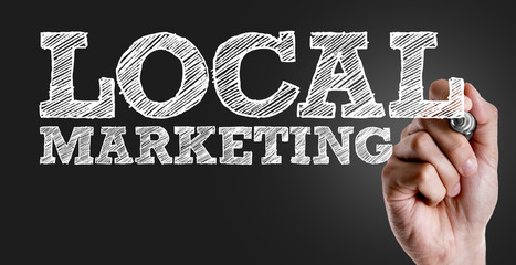 Hand writing the text: Local Marketing