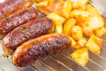 Grilled meat sausages with fried potatoes