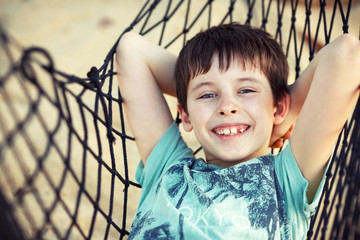 Cute little boy relaxing in a hammock