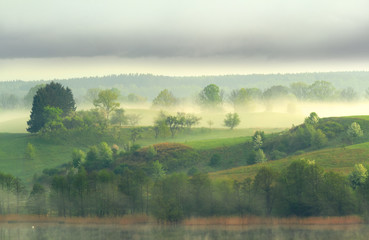 Warmia i Mazury - pagórki, jezioro, mgła.