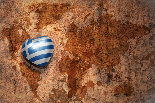 heart with national flag of greece on a vintage world map crack paper background