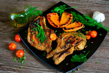 steak with grilled tomato, greens and vegetables