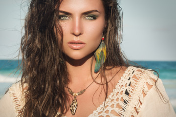Woman wearing a wooden pendant and feather earrings