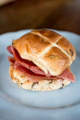 Cross Bun on a White Round Plate