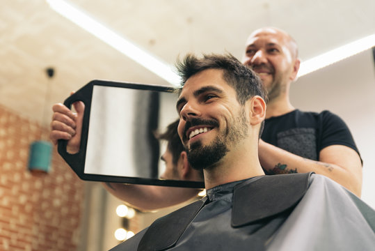 Hairdresser showing his work..