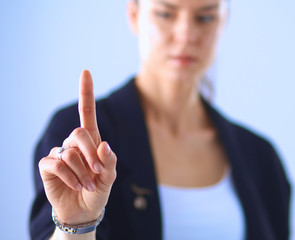Woman touching an imaginary screen with her finger 