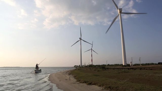 Scenic view of rotating turbines of wind farm on the shores of Puttalam Lagoon in Sri Lanka 