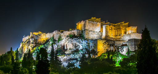 Parthenon and Herodium construction in Acropolis Hill in Athens, Greece shot in blue hour with moon...