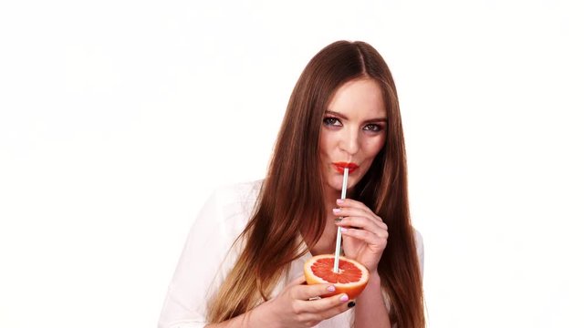 Woman holds grapefruit drinking juice from fruit 4K