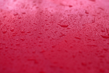 Rain drops on red background