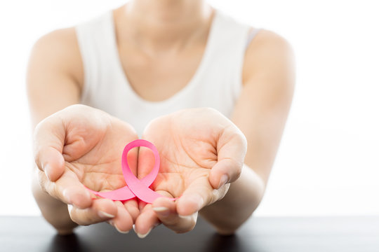 .Pink Breast cancer awareness ribbon holding by woman