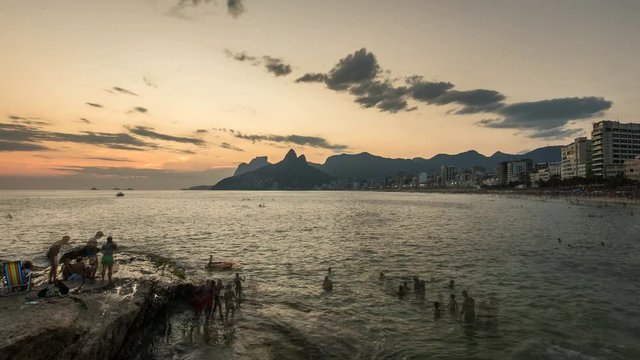 People watching sunset on famous Ipanema Beach in Rio de Janeiro