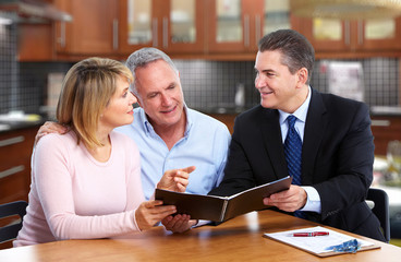 Senior couple with insurance agent.