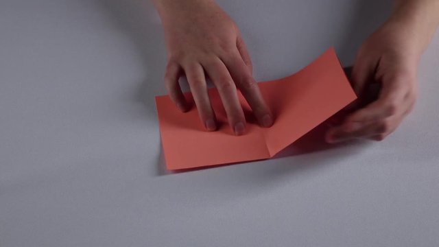 Woman makes paper windowsill. White. Time lapse