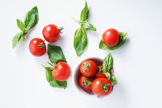 red ripe tomatoes and basil leaves