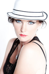 Portrait of blue eyes woman in a white hat.