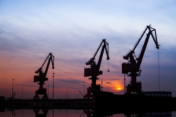 Fototapeta na wymiar In the evening, portal crane in freight terminal