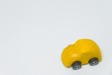 Yellow toy car with white background and selective focus