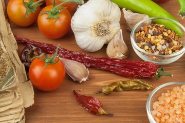 Spices and vegetables on wooden table. Preparing vegetable dishes. Diet food.
