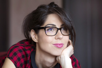 Fototapeta premium Portrait of beautiful young woman with modern eyeglasses with black frame