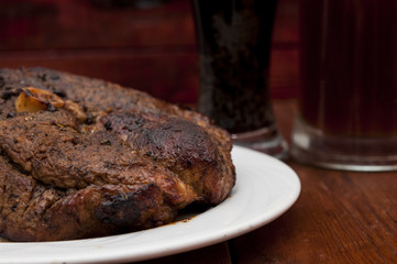 steak and beer on a wooden background