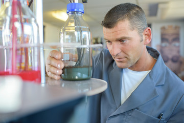 Man looking at glass jar