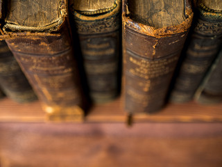 Pile of old antique books on the table. Shallow focus