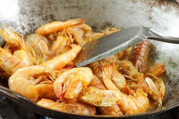 Silver Mantis Shrimp and Prawn cooked in the wok. In the middle of cooking process.
