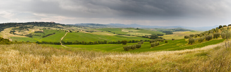 Tuscany wheat field hill panorama before a storm