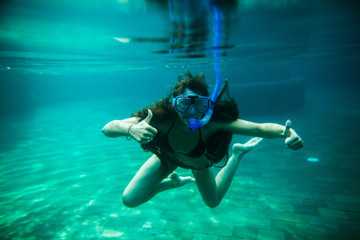 woman swim underwater pool with snorkel