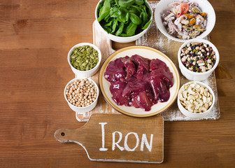 Foods high in Iron on wooden board.