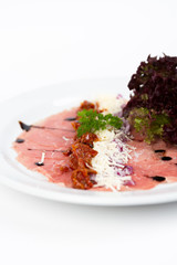 Image of tasty carpaccio with salad and cheese
